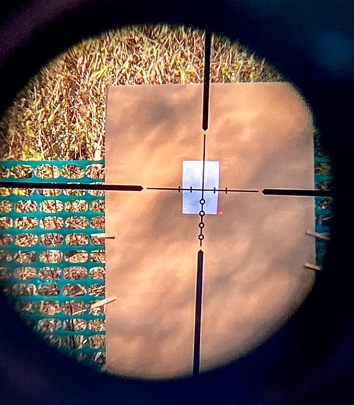 Adjust your scope so the crosshairs meet the red laser dot.