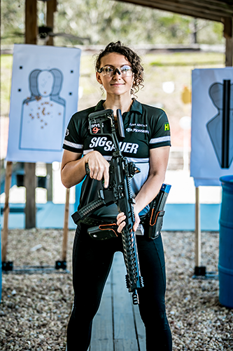 Lena Miculek standing in front of targets